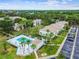 Aerial shot of a community with a pool, palm trees, and a well-maintained parking area at 413 Meadow Ln # 81, Oldsmar, FL 34677