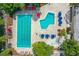 Overhead shot of the community pool area with multiple pools, lounge chairs, and vibrant landscaping at 413 Meadow Ln # 81, Oldsmar, FL 34677