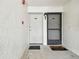 Exterior of condo entrance with welcome mat, doors, and fire safety system at 413 Meadow Ln # 81, Oldsmar, FL 34677
