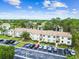 Lovely condo buildings surrounded by lush trees and landscaping, with ample parking on a beautiful sunny day at 413 Meadow Ln # 81, Oldsmar, FL 34677