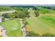 Scenic aerial view of the golf course with well-maintained fairways, ponds, and lush green surroundings at 413 Meadow Ln # 81, Oldsmar, FL 34677