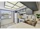 Well-lit kitchen with stainless steel sink, gray cabinets, and mosaic backsplash at 413 Meadow Ln # 81, Oldsmar, FL 34677