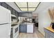 Updated kitchen featuring gray cabinets, modern appliances, and a view into the living area at 413 Meadow Ln # 81, Oldsmar, FL 34677