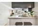 Well-lit kitchen featuring a modern sink, sleek countertops, and overhead storage cabinets at 413 Meadow Ln # 81, Oldsmar, FL 34677
