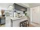 Bright kitchen features bar seating, stainless steel sink, and modern lighting at 413 Meadow Ln # 81, Oldsmar, FL 34677