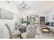 Bright living room features neutral tones, contemporary furniture, and a glass dining table set for four at 413 Meadow Ln # 81, Oldsmar, FL 34677