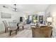 Bright living room area with stylish furniture, a dining table, and sliding glass doors to the patio at 413 Meadow Ln # 81, Oldsmar, FL 34677