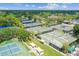Aerial view showcasing the numerous tennis courts surrounded by lush trees in a well-maintained community at 413 Meadow Ln # 81, Oldsmar, FL 34677
