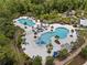 Aerial view of the luxurious community pool area with waterslide and palm trees at 4264 Bexley Village Dr, Land O Lakes, FL 34638