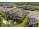 Residential homes with solar panels on roofs, lush green lawns, and tree-lined streets at 4264 Bexley Village Dr, Land O Lakes, FL 34638