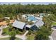 Aerial view showing the community clubhouse, pool, playground, and surrounding lush landscape at 4264 Bexley Village Dr, Land O Lakes, FL 34638