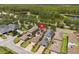 Aerial view of a home in a residential area, with solar panels and lush trees surrounding at 4264 Bexley Village Dr, Land O Lakes, FL 34638