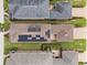 Aerial view of a home with solar panels on the roof and a brick-paved driveway at 4264 Bexley Village Dr, Land O Lakes, FL 34638