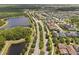 Panoramic aerial view of property with lake, modern homes, and landscaped streets, ideal for tranquil living at 4264 Bexley Village Dr, Land O Lakes, FL 34638