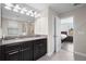 Spacious bathroom featuring double sinks, granite countertops, and tile flooring with an open doorway to the bedroom at 4264 Bexley Village Dr, Land O Lakes, FL 34638