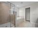 Bright bathroom with a glass-enclosed shower and a soaking tub illuminated by natural light from the window at 4264 Bexley Village Dr, Land O Lakes, FL 34638