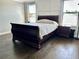 Well-lit bedroom features dark wood flooring and traditional-style furniture at 4264 Bexley Village Dr, Land O Lakes, FL 34638