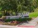 Bexley Club community sign surrounded by lush landscaping and colorful flowers at 4264 Bexley Village Dr, Land O Lakes, FL 34638
