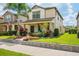 Charming two-story home featuring a welcoming front porch and beautifully landscaped front yard at 4264 Bexley Village Dr, Land O Lakes, FL 34638