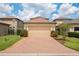 Charming home with a paved driveway leading to a two-car garage, complemented by neatly manicured landscaping at 4264 Bexley Village Dr, Land O Lakes, FL 34638