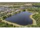 Aerial view of a serene lake surrounded by lush greenery and walking trails, perfect for outdoor enthusiasts at 4264 Bexley Village Dr, Land O Lakes, FL 34638