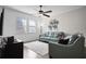 Bright living room with hardwood floors, a ceiling fan, and comfortable seating with unique wall decor at 4264 Bexley Village Dr, Land O Lakes, FL 34638