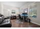 Bright home office with wood floors, dual monitors, and a comfortable sitting area at 4264 Bexley Village Dr, Land O Lakes, FL 34638