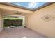 Cozy outdoor patio with brick pavers, a ceiling fan, and view of a lush privacy hedge at 4264 Bexley Village Dr, Land O Lakes, FL 34638