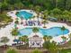 Resort-style pool area with palm trees, lounge chairs, water slide, and ample space for relaxation and recreation at 4264 Bexley Village Dr, Land O Lakes, FL 34638