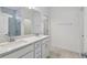 Bathroom featuring double sinks, spacious countertops, and a tiled shower at 4303 Big Sky Dr, Spring Hill, FL 34604