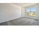 Cozy bedroom with large window offering neighborhood views and soft carpeting at 4303 Big Sky Dr, Spring Hill, FL 34604