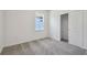 Bright bedroom with sliding closet doors, a window, and neutral carpeting at 4303 Big Sky Dr, Spring Hill, FL 34604
