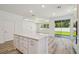 Spacious kitchen with island open to adjacent living area and sliding glass door to the back yard at 4303 Big Sky Dr, Spring Hill, FL 34604