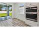 Modern kitchen with stainless steel appliances and sliding door to backyard at 4303 Big Sky Dr, Spring Hill, FL 34604
