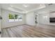 Open-concept living space with plank flooring and large window at 4303 Big Sky Dr, Spring Hill, FL 34604