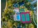 Aerial view of community amenities including a pool, tennis courts, basketball court, playground, and lake at 455 Cypress Lake Ct, Oldsmar, FL 34677
