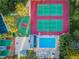 Aerial view of tennis courts, basketball court, and swimming pool with clear blue water on a sunny day at 455 Cypress Lake Ct, Oldsmar, FL 34677