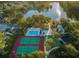 Aerial view of community amenities including tennis courts, pool, hot tub, lake, playground, and clubhouse at 455 Cypress Lake Ct, Oldsmar, FL 34677