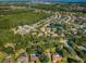 Beautiful aerial view of a subdivision featuring mature trees and well-maintained landscaping and a pond at 455 Cypress Lake Ct, Oldsmar, FL 34677
