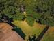 Aerial view showcasing a large backyard with mature trees, partially fenced, providing an outdoor space at 455 Cypress Lake Ct, Oldsmar, FL 34677