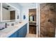 Modern bathroom with a walk-in shower with beige tiling, updated vanity, and tiled flooring at 455 Cypress Lake Ct, Oldsmar, FL 34677