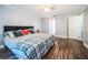 Bright bedroom featuring hardwood floors, a comfortable bed, and neutral decor at 455 Cypress Lake Ct, Oldsmar, FL 34677