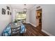 Dining room features wood floors and glass doors to the backyard with view of the kitchen at 455 Cypress Lake Ct, Oldsmar, FL 34677