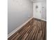 Bright entryway featuring wood-look floors, a decorated door, and a welcoming 'Home Sweet Home' wall decor at 455 Cypress Lake Ct, Oldsmar, FL 34677