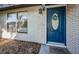 Close-up of a stylish blue front door with decorative wreath and sidelight window for natural light at 455 Cypress Lake Ct, Oldsmar, FL 34677