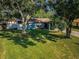 Charming single-story home with a well-manicured front lawn and mature trees at 455 Cypress Lake Ct, Oldsmar, FL 34677