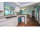 Bright kitchen featuring wooden floors, countertops with view of living room at 455 Cypress Lake Ct, Oldsmar, FL 34677