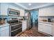 Kitchen with stainless steel appliances, wooden floor and access to the dining area at 455 Cypress Lake Ct, Oldsmar, FL 34677