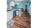 Well-lit kitchen and breakfast bar boasting stylish wood floors and appliances at 455 Cypress Lake Ct, Oldsmar, FL 34677