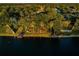 Lakeside view from community access showing mature trees and peaceful setting at 455 Cypress Lake Ct, Oldsmar, FL 34677